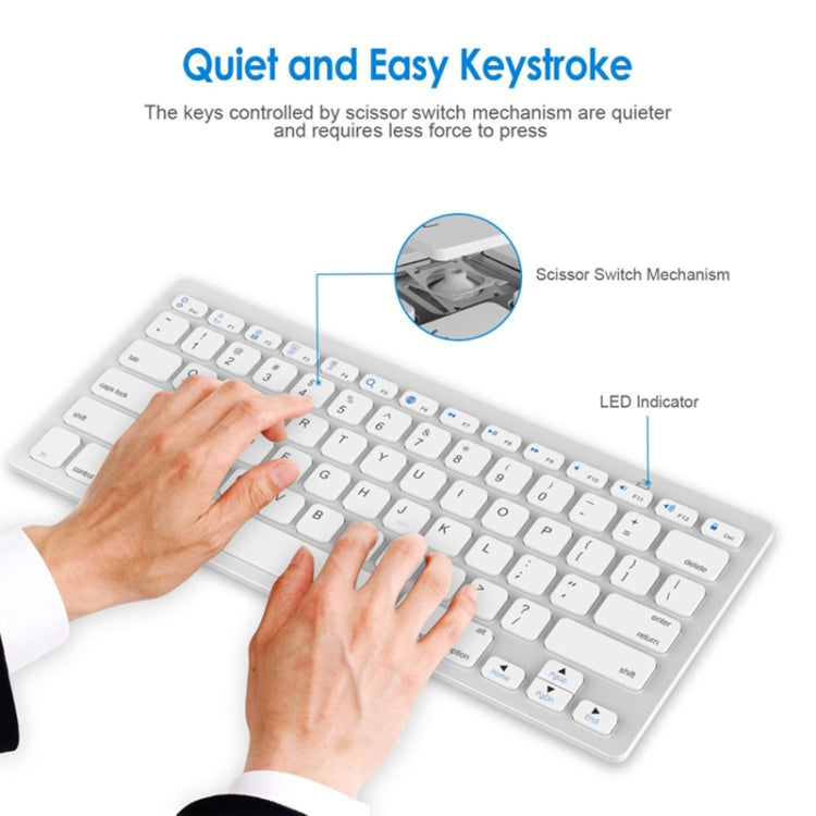 White ultra-thin wireless keyboard, hands typing, scissor-switch key area shown
