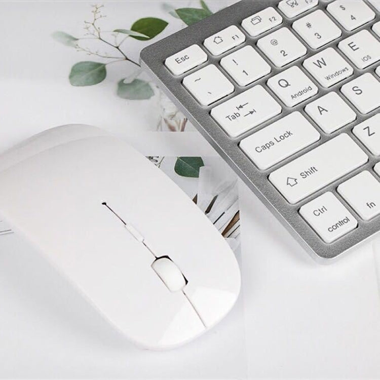 Light gray wireless keyboard with white wireless mouse, top corner view
