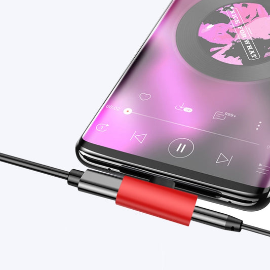 USB-C charging and audio adapter with red housing and USB-C connector