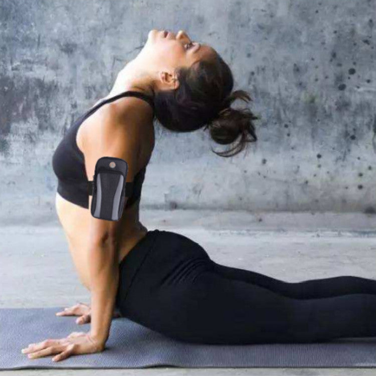 Black smartphone armband with gray window and top flap, worn on forearm.