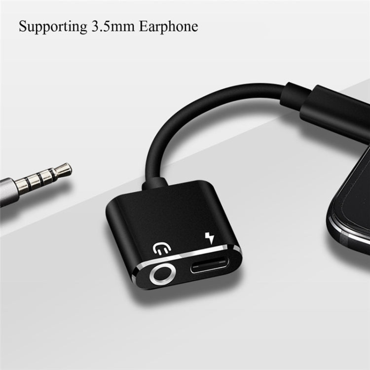 Black USB-C earphone adapter with 3.5mm audio jack and USB-C charging pass-through