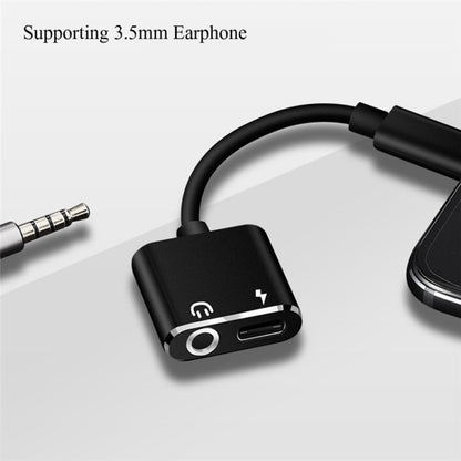 Black USB-C earphone adapter with 3.5mm audio jack and USB-C charging pass-through