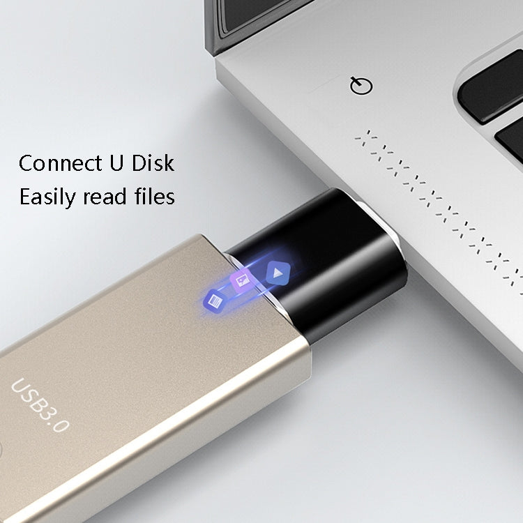 Black USB 3.0 to USB-C OTG adapter connected to a USB device with blue port