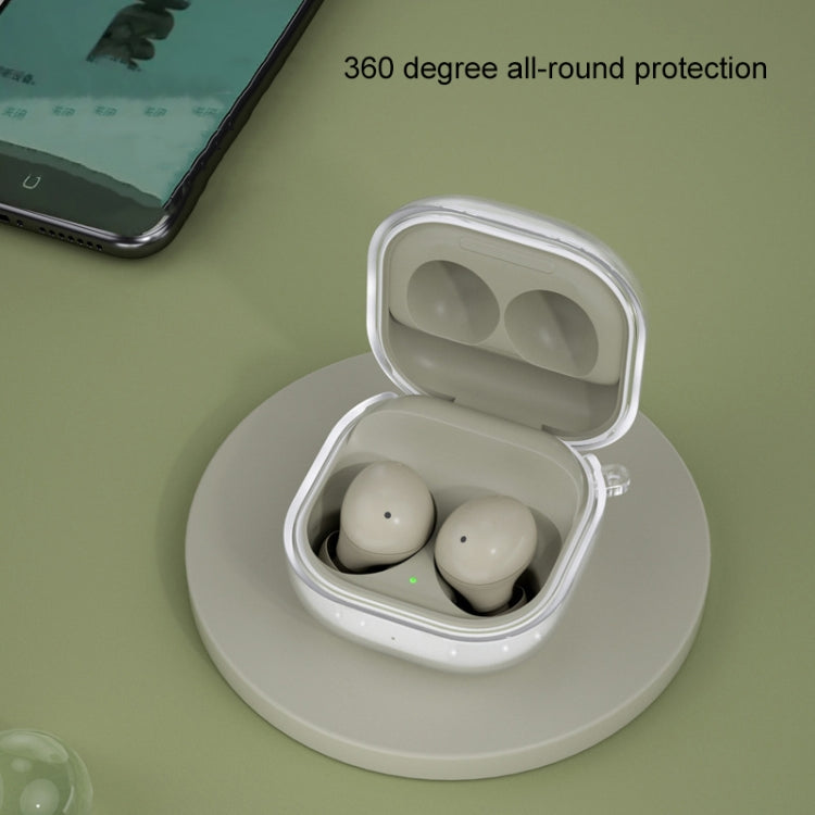 Glitter transparent TPU earbud case on charging base, holding two white earbuds