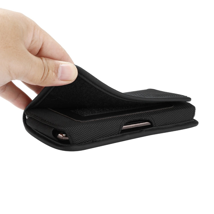 Black nylon flip phone case opening with a partial phone inside the slot