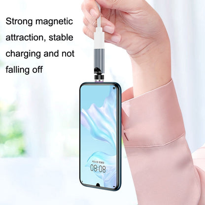 Magnetic charging cable connecting to a smartphone while held in a hand