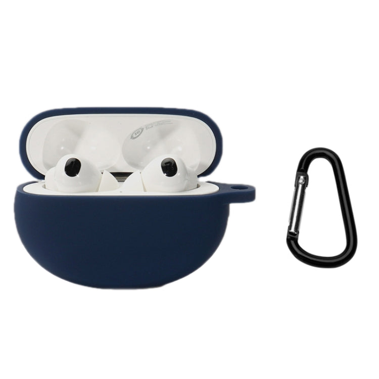 Navy silicone earbud case with open lid, earbuds and black keychain hook.