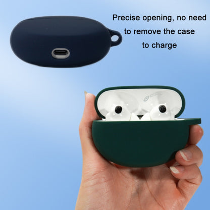 Green silicone earbud case held in hand with charging port opening.