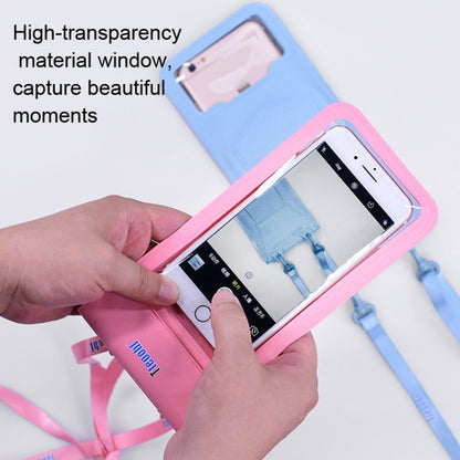 Blue waterproof phone pouch with pink border, held open while inserting a phone