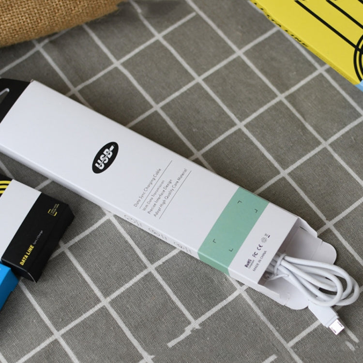 White cable storage carton packaging with built-in cable and USB charging plug accessories.