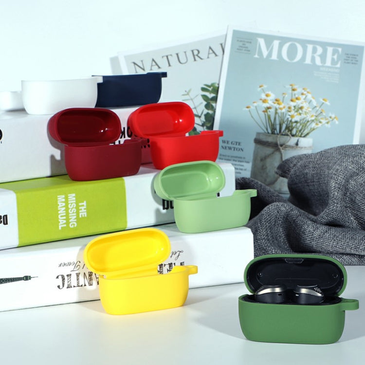 Multi-color soft silicone charging cases for wireless earbuds with lids open on tabletop