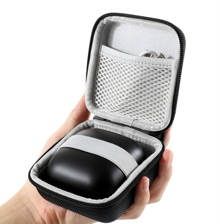 Hard-shell earbuds storage bag held in hand, open with black molded holder
