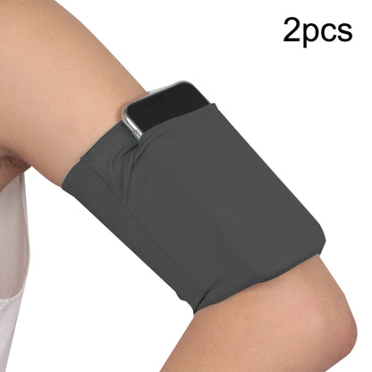 Dark gray elastic phone armband set with secure pocket on wearer’s arm (2-pack).
