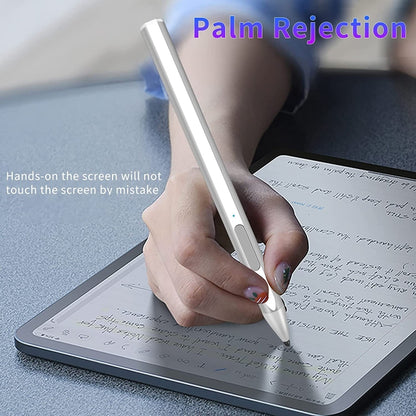 Hand using a silver stylus on a tablet screen for writing