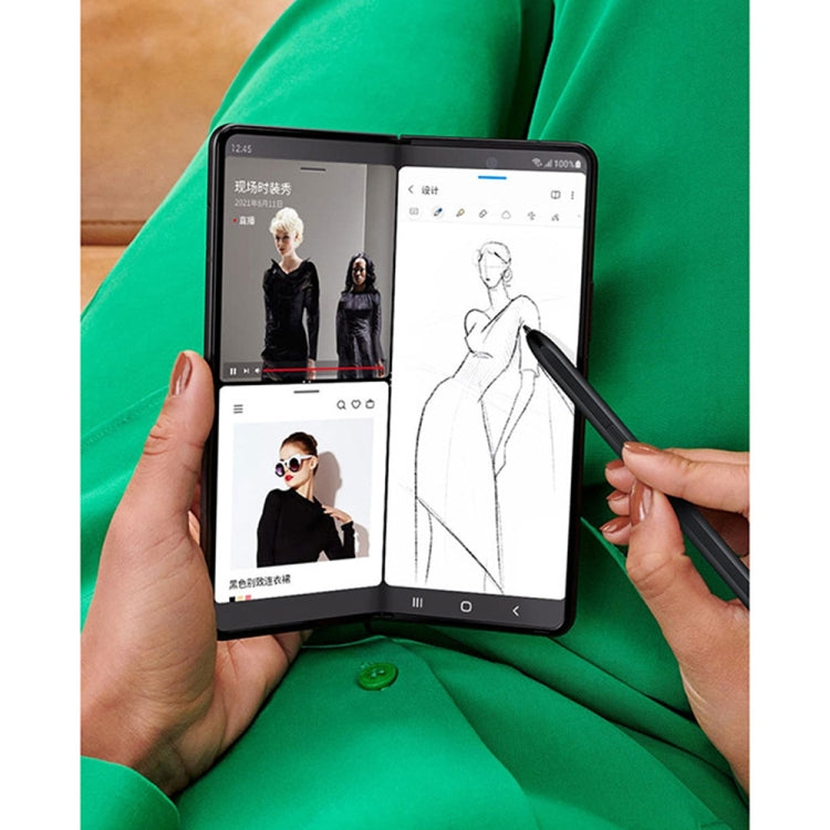 Hands using black stylus pen to draw on Samsung Fold4 tablet display