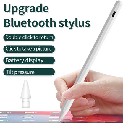 Bluetooth stylus pen held by hand over tablet screen, pointed tip touching