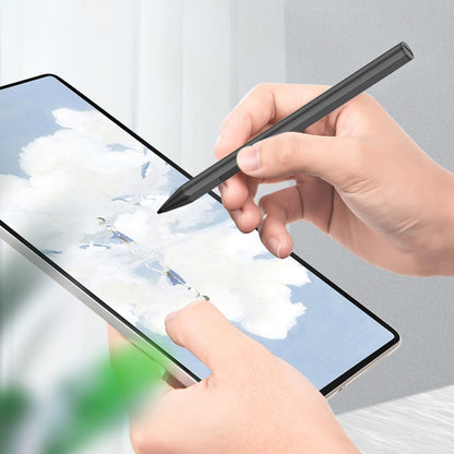 Black pressure-sensitive stylus pen held above a tablet screen for writing.