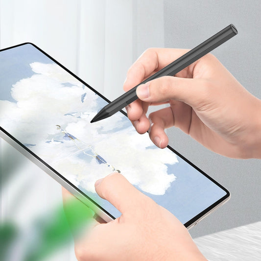Black pressure-sensitive stylus pen held above a tablet screen for writing.