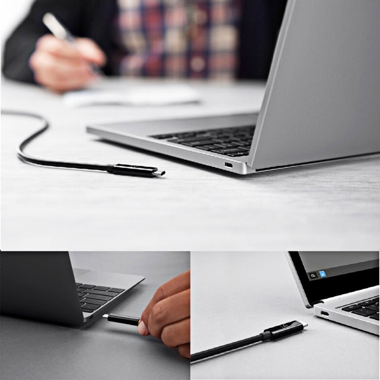 USB-C to USB-C coiled cable connected to a laptop for charging and data