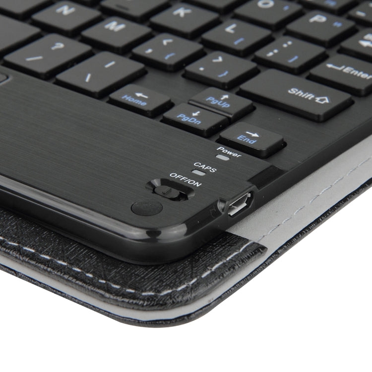 Close-up of keyboard corner with ports and power/controls on black touchpad case