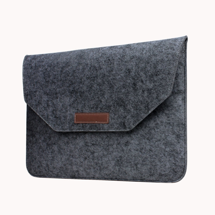 Grey felt laptop sleeve with envelope flap and centered brown leather-look patch