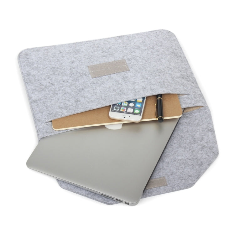 Grey felt sleeve bag with front label patch, holding a laptop and tablet