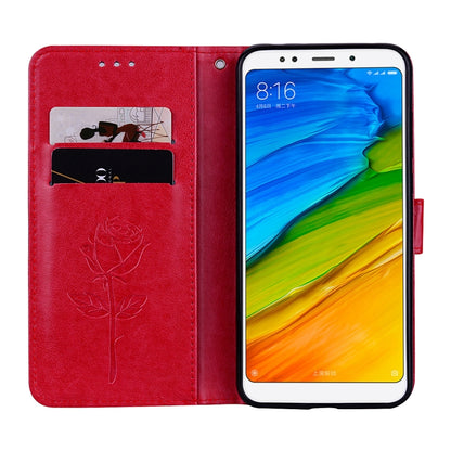 Red rose-embossed flip wallet case with card slot window and phone in stand view