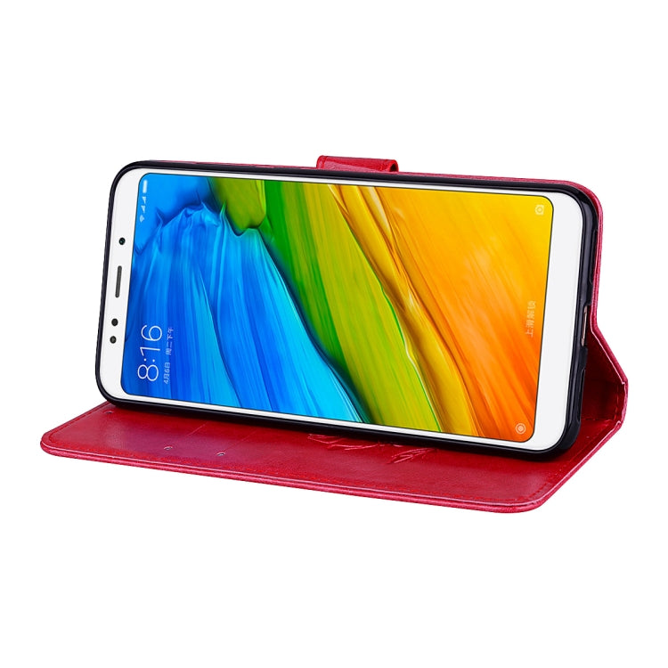 Red PU leather flip wallet case folded as a horizontal stand for phone