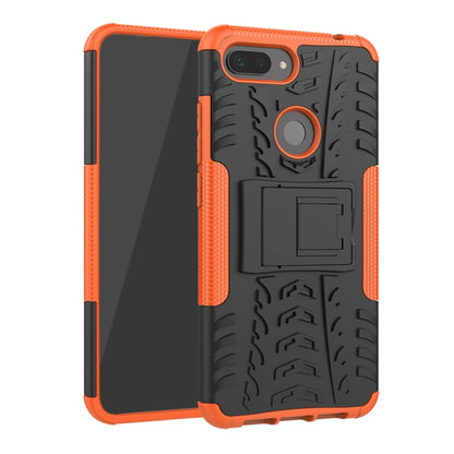 Rugged orange phone case with tire tread texture, camera cutout, and built-in holder