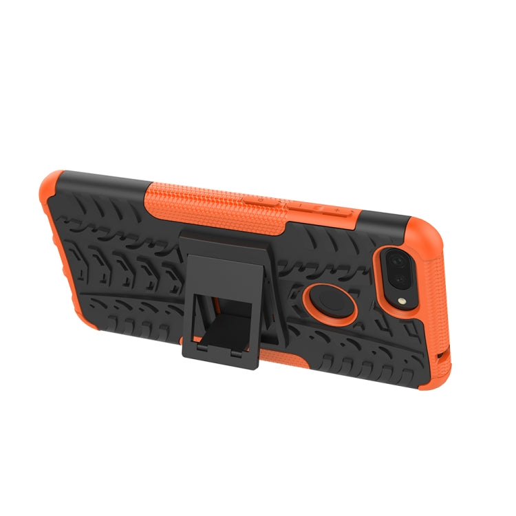 Rugged orange-and-black phone case with kickstand-style holder and camera cutout