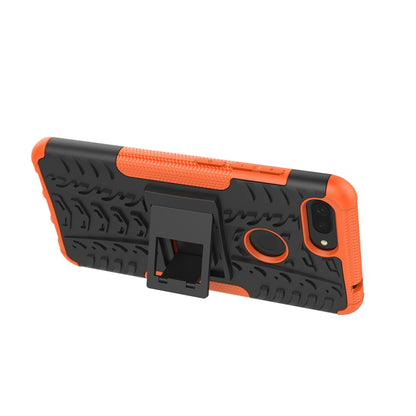 Rugged orange-and-black phone case with kickstand-style holder and camera cutout