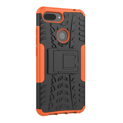Rugged orange phone case back with tire tread texture, ring grip, and camera cutout