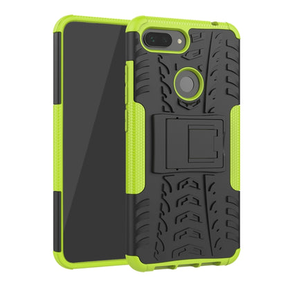 Rugged green phone case with tire tread texture, ring stand, and camera cutout