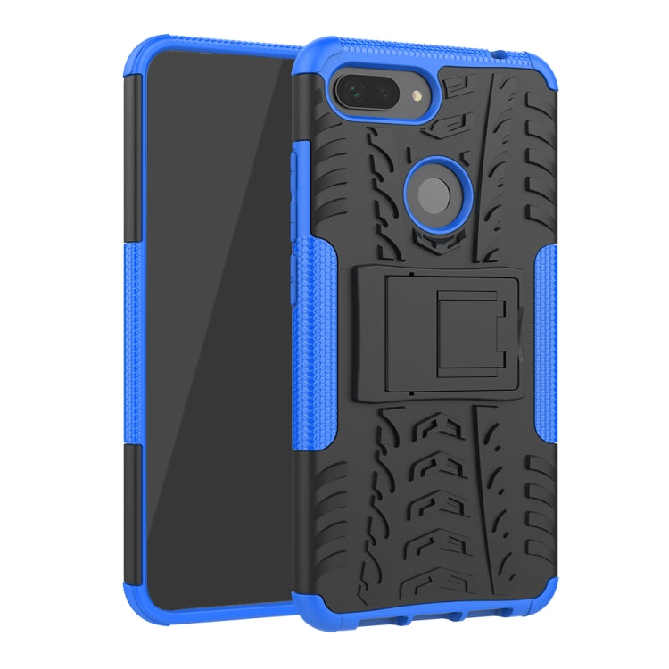 Rugged blue phone case with tire tread texture, ring stand, and camera cutout