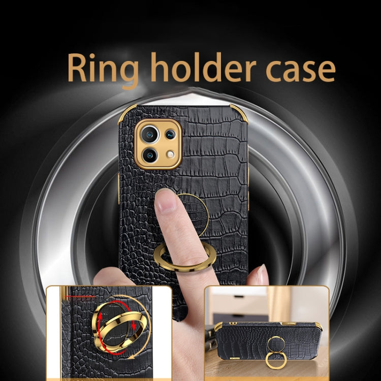 Black crocodile-pattern phone case with gold ring holder, finger visible