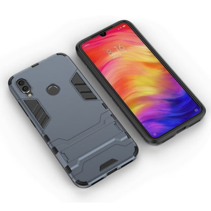 Navy blue shockproof phone case with raised armor pattern, back and front views