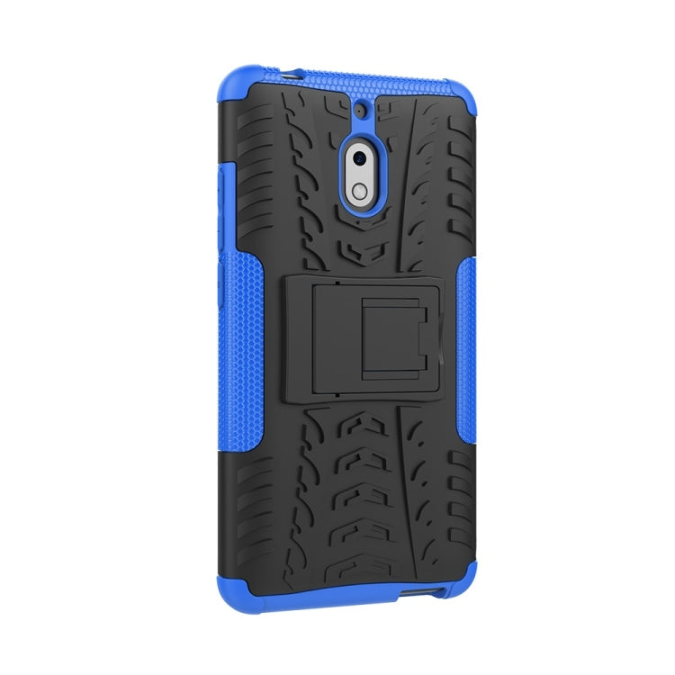 Blue and black tire-textured phone case with camera cutout and built-in holder